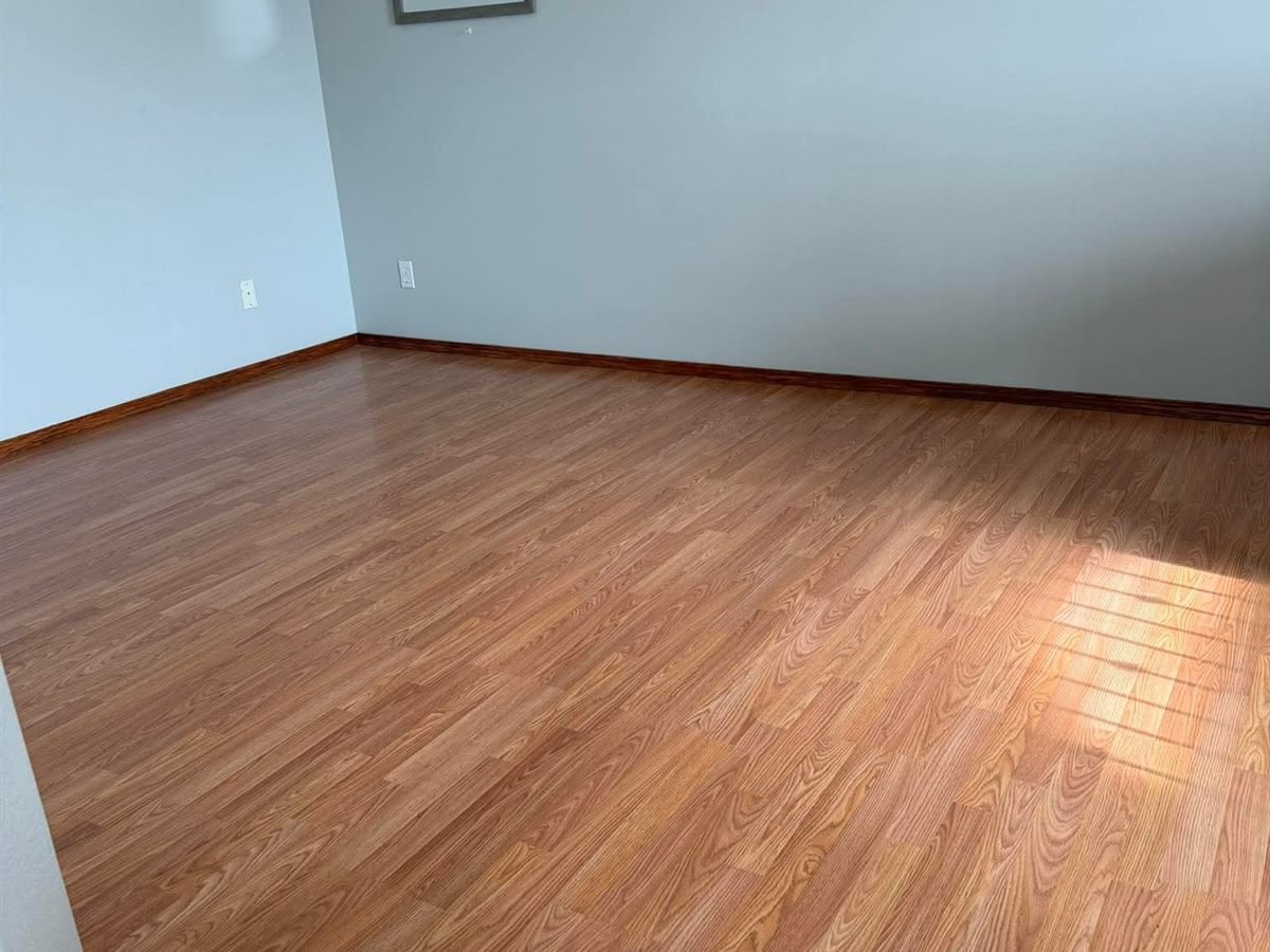 Empty room with a polished hardwood floor
