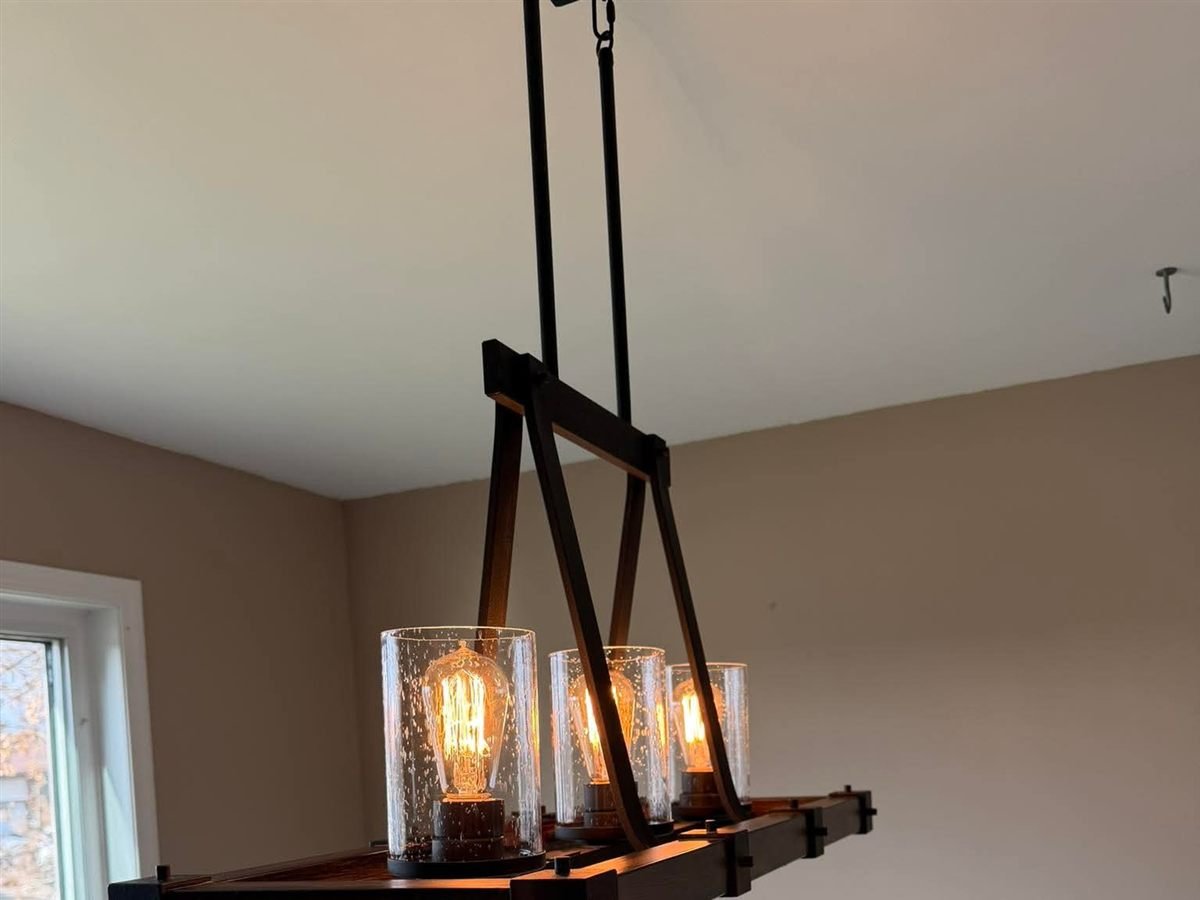 Room with a pendant light fixture and a window